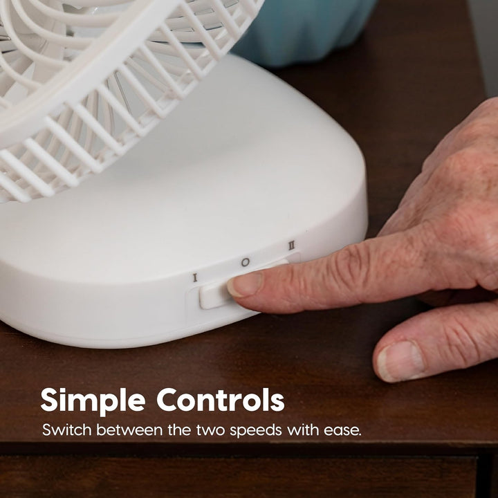 Hand adjusting a white fan on a wooden surface with text 'Simple Controls'.