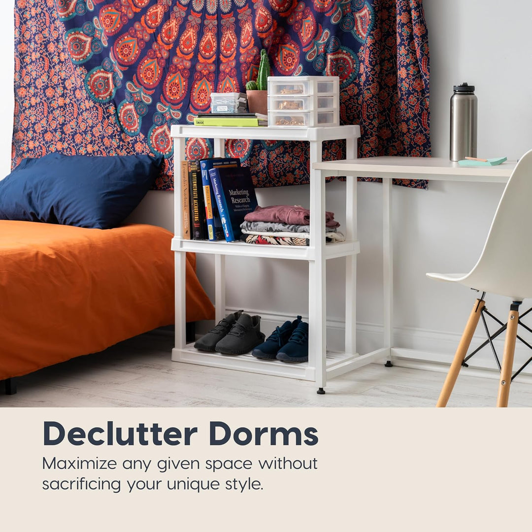 Dorm room with a bed, desk, and chair, featuring a tapestry and books.